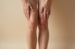 © Vadym - Close-up of female legs with visible skin imperfections, varicose veins, cellulite. Woman touches knees, emphasizing concern about health, beauty. Body care, dermatology, aesthetic, cosmetic,