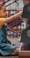 Poster - Girl, student and bookshelf with choice for story, novel or selection in school library. Child, kid or elementary learner with decision or books for knowledge, literature or childhood development
