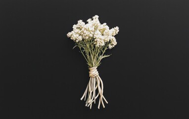 Poster - Small bouquet of white flowers with long stems, tied together with twine, levitating against a stark black background. The image has a minimalist and slightly surreal feel