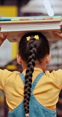 Poster - Child, student and books on head in library with knowledge, research and information on story. Back, girl and walking with novel for creative reading, literature development and studying for learning