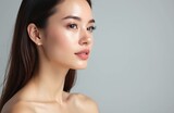 Attractive young woman in profile with perfect skin. Brunette lady, plump lips, nude shoulders. Facial beauty, cosmetology. Spa, skincare, bodycare, wellness. Healthy, clean skin tone. Grey