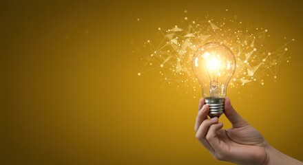 Poster - Hand holding a glowing lightbulb with abstract light effects on yellow background.