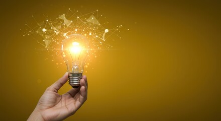 Poster - Hand holding lightbulb with glowing particles against a yellow background.