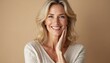 © Vadym - Beautiful middle-aged woman with blond hair smiles. Attractive caucasian female face close-up. Happy, healthy woman in 40s on beige background. Confident woman shows natural beauty, fresh face.