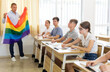 © JackF - School teacher with flag explains to students what is LGBT in schoolroom