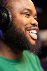 Poster - Happy enthusiastic sound designer feeling cheerful composing music, doing what he loves in his home studio. Positive smiling musician producing new soundtracks with stereo gear. Close up.