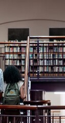 Poster - Happy, people and students walk in library with discussion, education and knowledge for team project. Man, woman and talking with books of college research, studying and learning assessment on stairs
