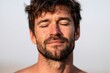 © Leo Rohmann - Bearded man with closed eyes under sunlight showing peaceful expression and calm masculine mood in bright natural environment lifestyle portrait image