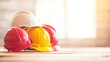 © tashechka - Brightly colored safety helmets are stacked on a wooden surface, reflecting an emphasis on safety in construction work settings