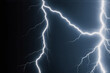 © YiuCheung - A dramatic close-up of a lightning bolt against a dark night sky.  The bright, jagged lines of electricity contrast sharply with the deep black background.
