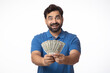 © Pix4Ads - Indian happy excited man showing currency on white background.