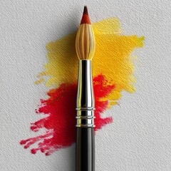 Poster - Paintbrush with Red and Yellow Pigment on Textured White Surface, a Creative Artistic Display.