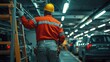 © MelodyStock - Worker in Safety Gear Monitors Parking Garage with Ladders and Tools