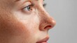 © Johannes - close up view of tender woman with freckles on face isolated on grey