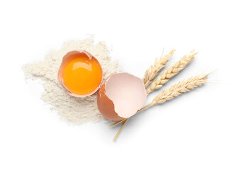 Wall Mural - broken chicken egg, flour and spikelets on white background