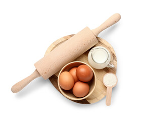 Wall Mural - wooden board with fresh chicken eggs, flour, milk and rolling pin on white background