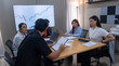 © Freeday photo - Group of professionals collaborating on a business project with charts displayed in a modern office setting
