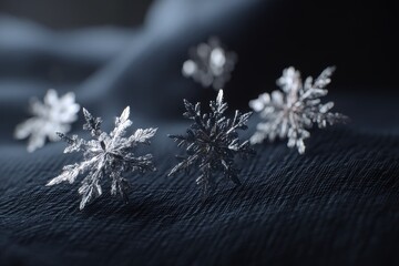 Poster - Close-up of several shimmering, intricately detailed snowflakes resting on a textured, dark blue surface, creating a wintery and elegant atmosphere, cold weather, holiday.