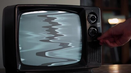 Wall Mural - male hand turning on old black television showing static noise then green screen, close up, 4k