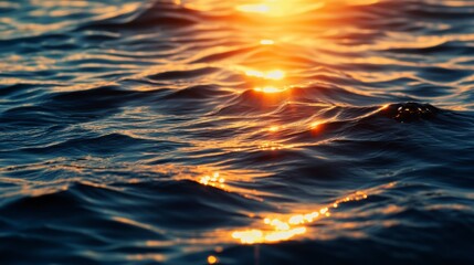 Wall Mural - golden sunset light reflecting on dark ocean water with small waves.