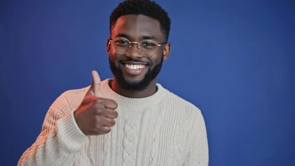 Poster - A person wearing glasses and giving a thumbs up in a casual setting.