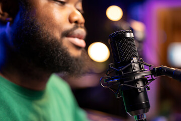Aufkleber - Singer performing his new track creation on a microphone, manipulates his audio files recordings with mixing and mastering techniques. Artist composer operates on stereo equipment. Close up.
