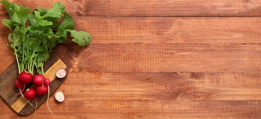 Wall Mural - Board and fresh radish on wooden background with space for text, top view