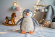 © Nashrin - Penguin plush toy on white backdrop, soft focus, bokeh lights, cozy nursery decor style, commercial product photo