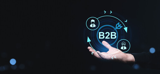 Poster - Business-to-business B2B digital concept with icons and network symbols above a hand on a dark creative background representing corporate communication.
