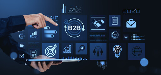 Poster - Businessman using tablet with B2B icons and analytics interface on dark background.