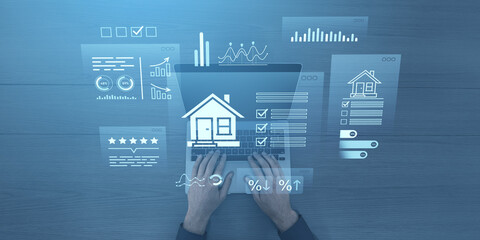 Poster - Hands typing on laptop with digital real estate analytics and property data interface on blue wooden background, representing mortgage investment concept.