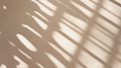 Poster - Soft shadows create an abstract pattern on a warm beige surface during daylight
