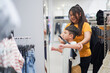 © DG PhotoStock - Happy Asian mother and little son are enjoy shop for the clothing or wardrobes in department store.