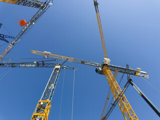 construction cranes. view from below. crane used to construct palaces, houses or buildings. construc