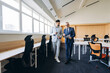 © Maria Vitkovska - Two businessmen discussing charts while walking in modern office