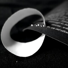 Poster - Abstract Swirl of Paper with Punctured Dots Creating a Modern Black and White Design Display.