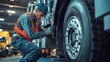 © Mas - Mechanic repairing truck tire in busy workshop environment