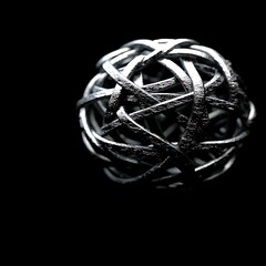Poster - Tangled Woven Wire Sphere Creates an Abstract Three Dimensional Metallic Sculpture Art Piece