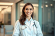 © Sync - Smiling woman doctor in white lab coat uniform with stethoscope, standing in a modern medical hospital clinic in professional healthcare service for hospitality and wellness in healthcare industry