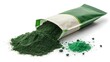 © ARIFUZZAMAN - Spirulina powder spilling from green and white package on white background
