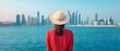 © Vibe Stock - Woman admiring a city skyline from the waterfront