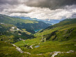 © Cdric - Panoramic alpine view over Roselend lake and winding trails, French Alps
