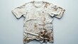 © Георгий Александрови - Worn and stained white t-shirt lying flat on a plain background showcasing signs of heavy use and dirt accumulation