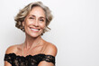 © aciddreamStudio - Mature woman smiles elegantly in a formal dress against a white background