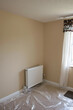 © lina - newly painted room with neutral beige walls and white floor protection