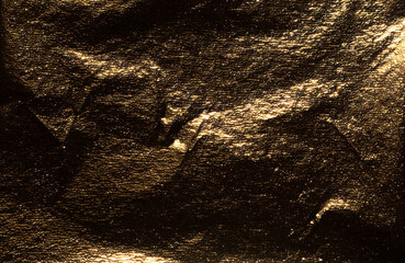 Aufkleber - Golden foil with dark, glossy texture creates a dramatic, reflective surface. Crumpled, burnished folds add moody elegance, while shimmer and glare enhance the luxury design. Perfect for premium.