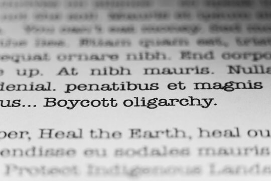 Boycott oligarchy. Text printed on a page. A piece of paper with a phrase written in retro typewriter font.