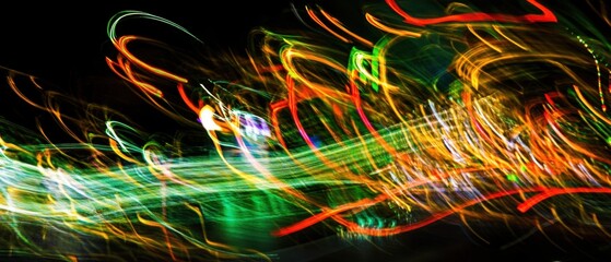Poster - Abstract light trails in vibrant colors creating a dynamic and energetic visual effect on a dark background