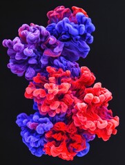 Poster - Abstract ink cloud in water with vibrant red and blue hues on a dark background creating a mesmerizing visual effect