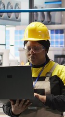 Poster - vertical video smart factory engineer using laptop to implement automated workflows and control syst